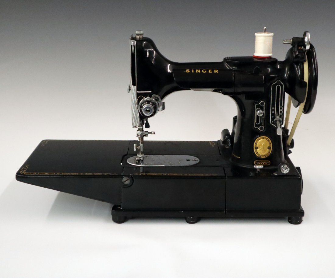 Singer 222K "Featherweight" Sewing Machine: A Mid 20th Century Singer "Featherweight" Sewing Machine. Model 222K with foot pedal and accessory box with six specialty feet. Extra bobbins included in a leatherette carrying case. Machine running w