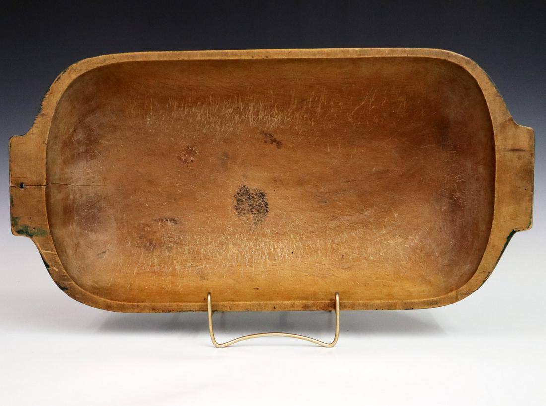 Wooden Dough Bowl: A Late 19th Century Dough Bowl. Oval maple bowl with handles at either side and old green painted exterior. Nice old interior surface; small split in one end, wear to paint. 10 1/4 x 21" x 3 1/2" high
