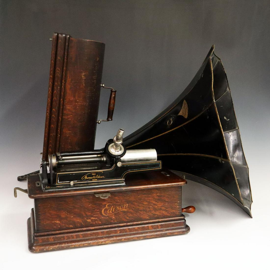Edison Phonograph: A Turn of the Century Edison "Model D" Phonograph. With a "Model C" Reproducer and a 20 1/2" "Home" horn in an oak case. Motor winds and runs, Arbor turns hard and no horn arm. Some finish loss to cas