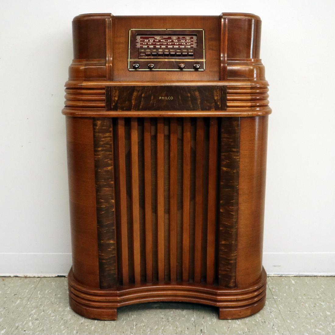 Philco Floor Radio: A 1940s Philco Floor Model Radio. No. 42.380 multi band radio in a mahogany case with contrasting walnut detail. Minor wear to case, older refinishing. 39 1/2" high. ESTIMATE $100-200
