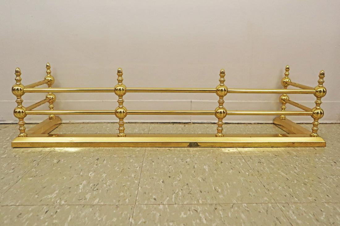 Fireplace Fender: An Edwardian Era Regency Style Fireplace Fender. Polished brass fender with six upright supports, two horizontal bars, and molded base. Minor tarnish at base. 41 3/4" x 13 3/4" x 10 3/4" high. ESTIMAT