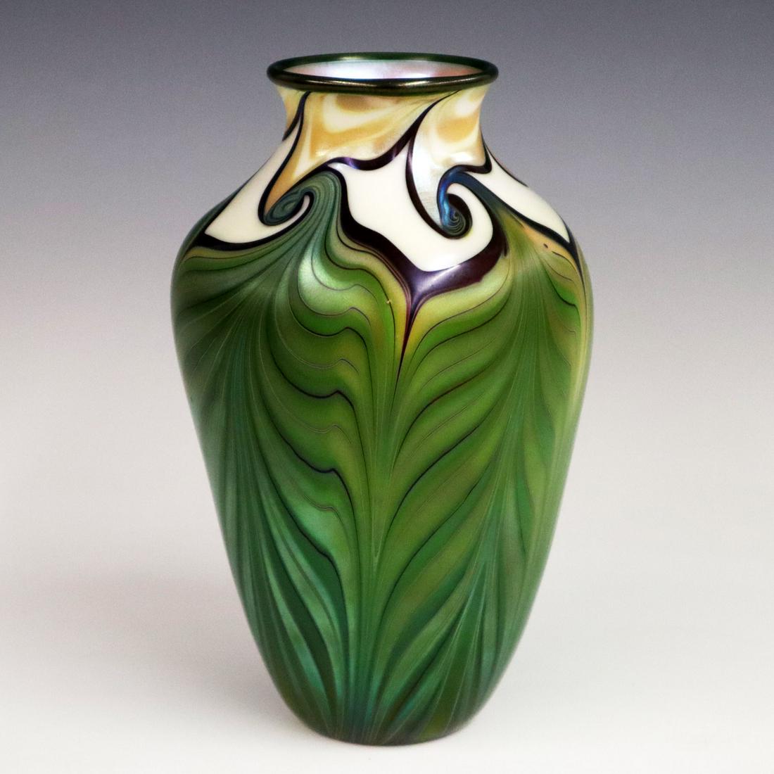 Orient & Flume Glass Vase: A Late 20th Century Orient & Flume Art Glass Vase. Baluster form vase with pulled feather design having ivory, blue, and gold at the neck and shoulder with green coloration about the body. Etched mark