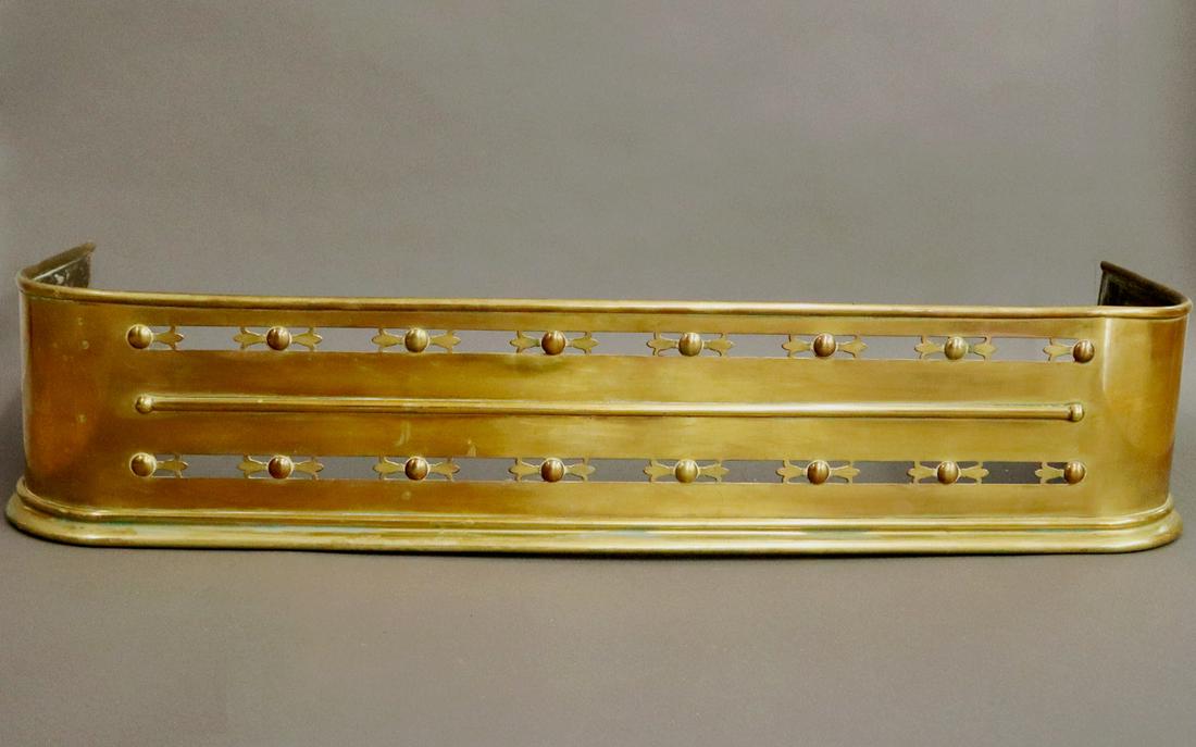 Fireplace Fender: A Mid 19th Century Pierced Brass Fireplace Fender. Overall tarnish, lacks one decorative piece at the side. 40 1/2 x 20 x 8 1/2" high. ESTIMATE $50-100