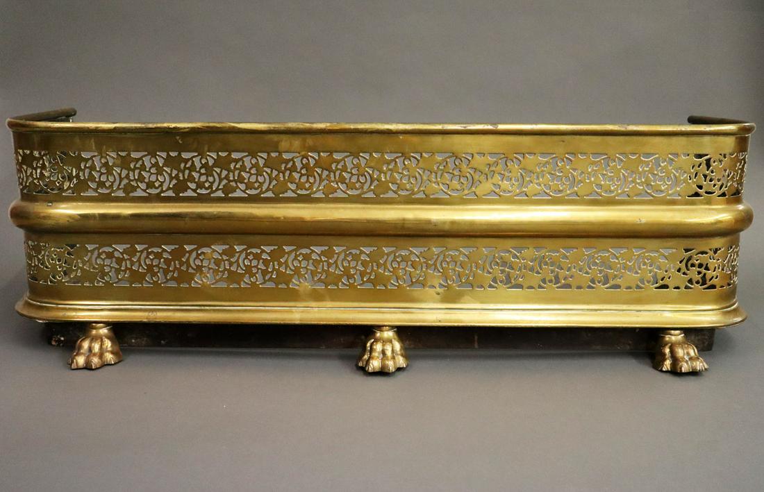 Regency Style Fender: A Mid 19th Century Regency Style Fire Fender. Pierced brass fireplace fender with sand cast paw feet. Overall tarnish, feet are slightly loose. 37 1/4 x 14 x 12" high overall. ESTIMATE $100-200