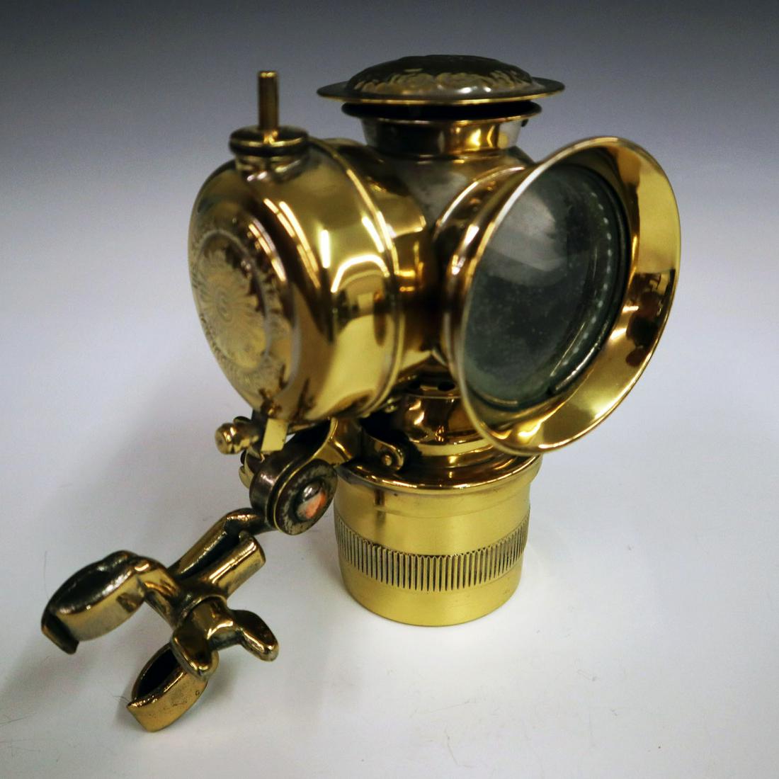 "Solar" Bicycle Lamp & Bracket: An Early 20th Century "Solar" Bicycle Lamp & Bracket. Polished brass lamp by The Badger Brass Mfg. Co., Kenosha, Wisconsin, with adjustable bracket. One key bent, was originally nickel plated. 6 3/4"