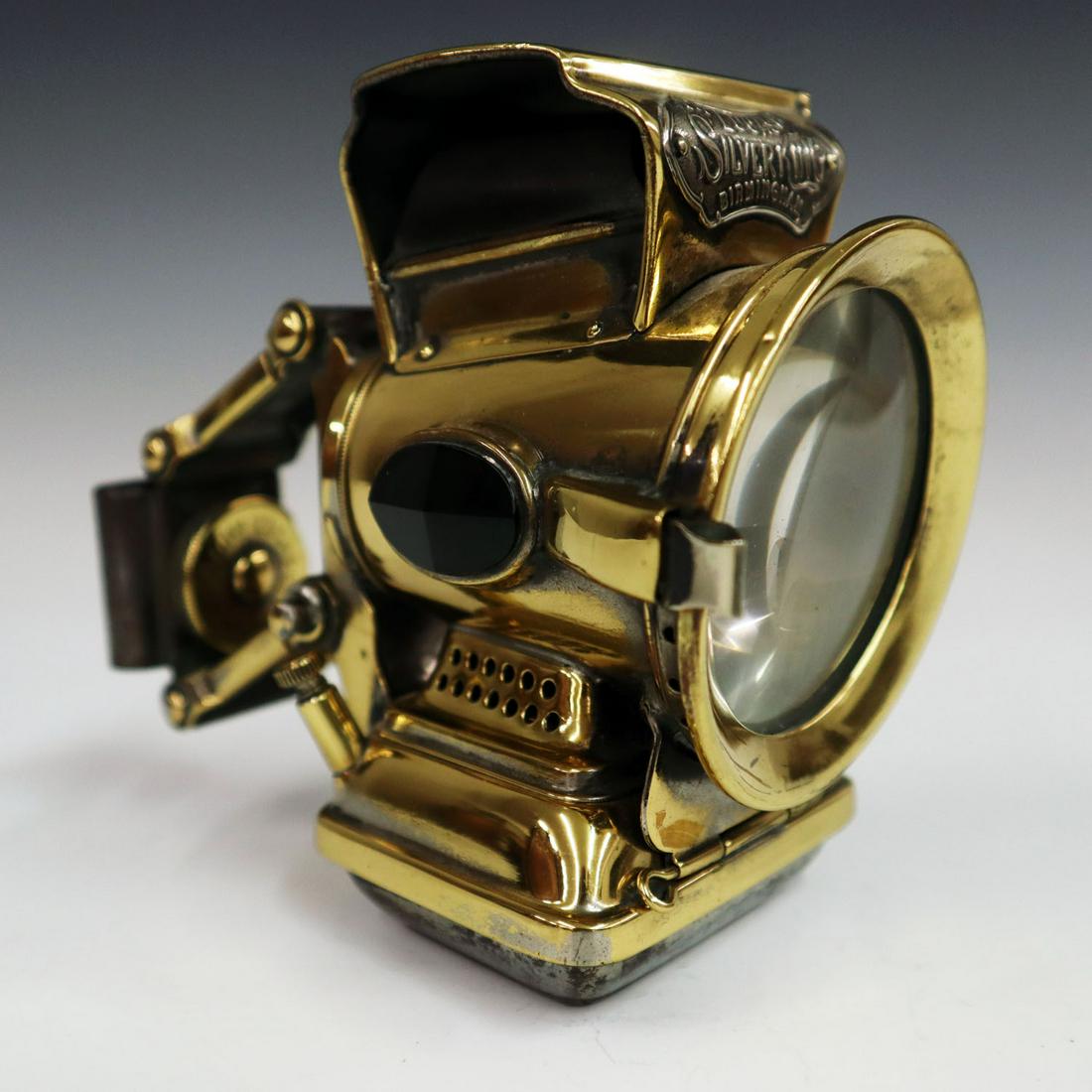 Silver King Bicycle Lamp: An Early 20th Century Silver King Bicycle Lamp. Polished brass lamp by Lucas Ltd, Birmingham, with bracket/handle at rear. Minor tarnish, was originally nickel plated. 5" high. ESTIMATE $50-100