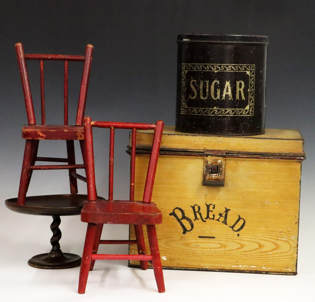 5 Kitchen Items: Five Early 20th Century Kitchen Items. Including 1 paint decorated tin bread box, 1 stenciled tin Sugar Tin, 1 turned wood Pastry stand, and a pair of rod back Miniature chairs in original finish. Min