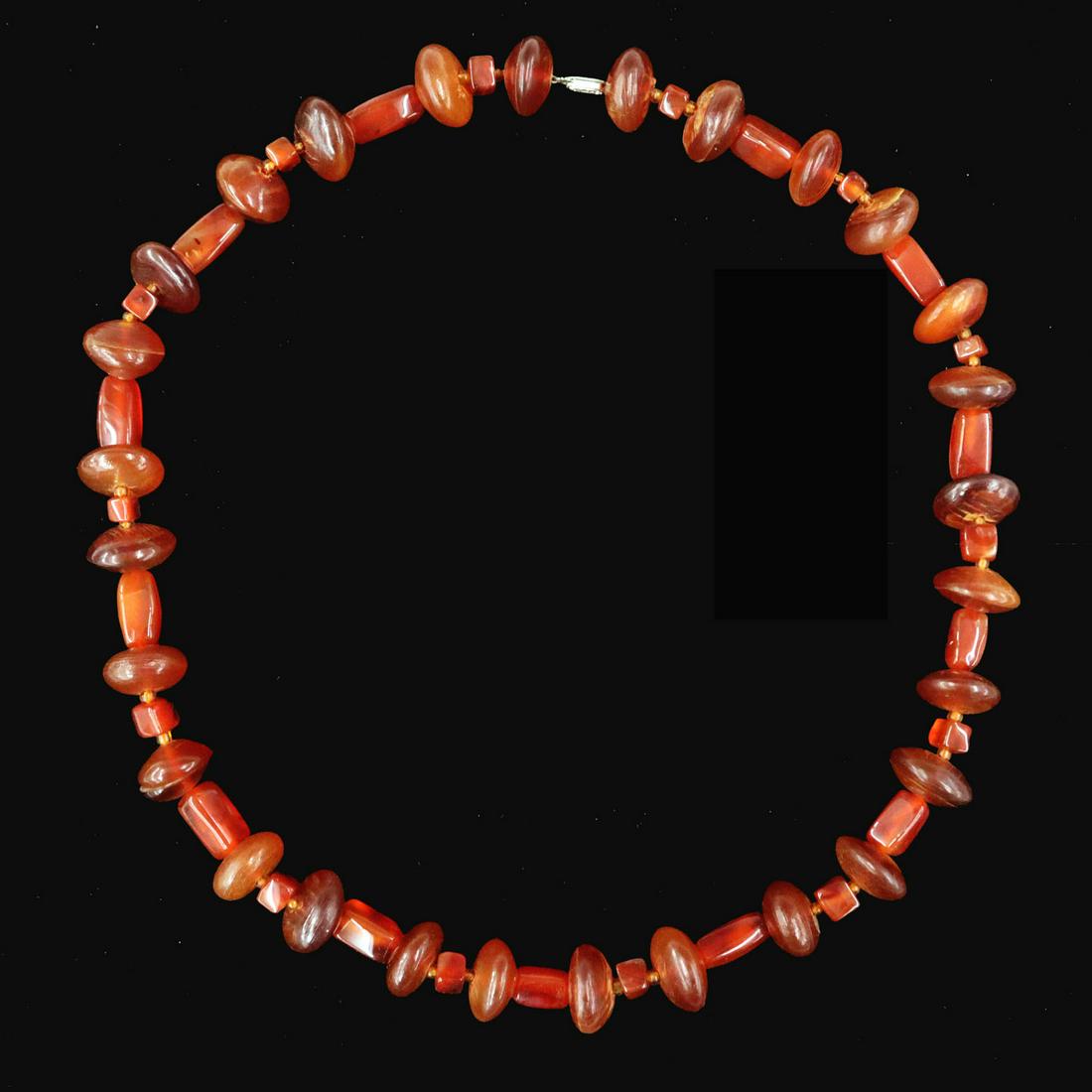 Carnelian & Horn Necklace: An Early 20th Century Carnelian & Horn Necklace. Beaded necklace comprised of carved oval horn beads and rectangular carnelian beads ending in a silver tone filigree closure. Needs cleaning. 27" long.