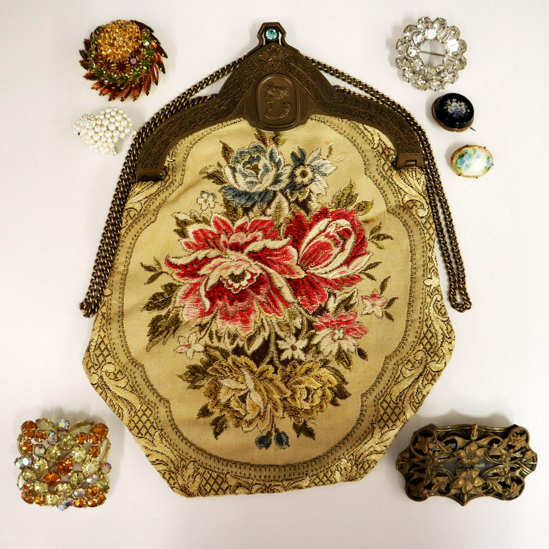 Embroidered Handbag & 7 Brooches: A Turn of the Century Embroidered Handbag & Seven Brooches. Cream colored handbag with embroidered floral design together with seven brooches consisting of 3 of the Edwardian era and 4 Mid 20th Centur