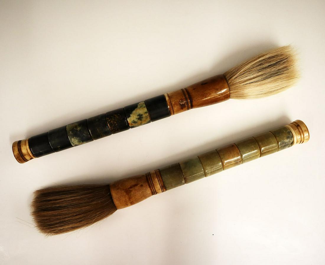 Pr. Japanese Calligraphy Brushes: A Pair of 20th Century Japanese Calligraphy Brushes. Comprised of hair bristles at the end of segmented soapstone and bone handles; each with a hole at the handle for hanging/displaying. The bone show