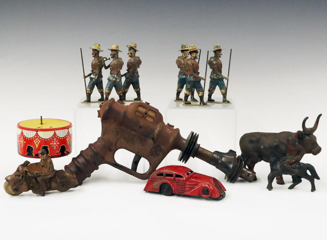 12 Antique Toys: Twelve Early to Mid-20th Century Toys. Including a Buck Rogers "Ray Gun", a cast iron Ox still bank, a cast iron Indian Scout, a hard rubber Motorcycle rider, a tin lithograph spinning toy, a lithogra