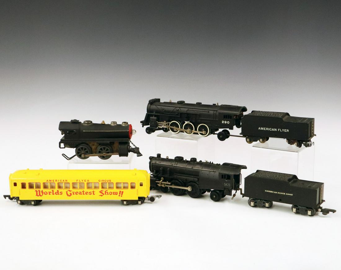 American Flyer Group: A Post-War S-Gauge American Flyer Group. Includes a pre-war clockwork locomotive, a 565 locomotive with 564 tender, a 290 locomotive and tender, and a "World's Greatest Show" passenger car. Wear and l
