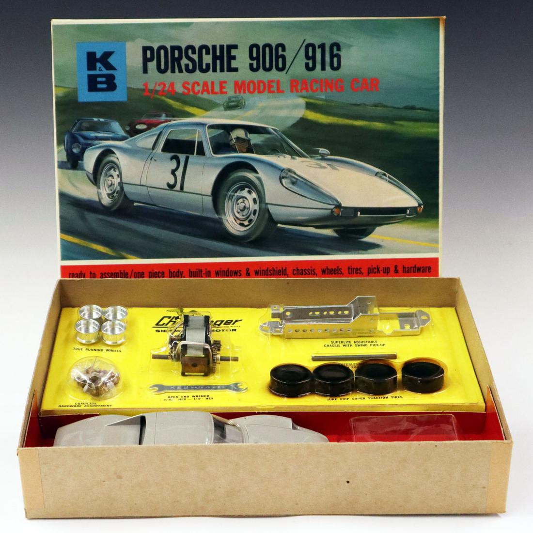 1960s K & B Porsche Model Kit: A 1960s K & B 906/916 Porsche 1/24 Scale Racing Slot Model Kit. Includes a "Challenger" sidewinder motor. In original packaging and box, never assembled. Wear to box corners and some blisters to label