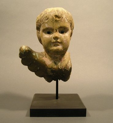 Putti: An 18th century Italian carved wooden bust of a putti. Old painted finish with some restoration, wear and some losses. 7 1/2" high, plus the display stand.