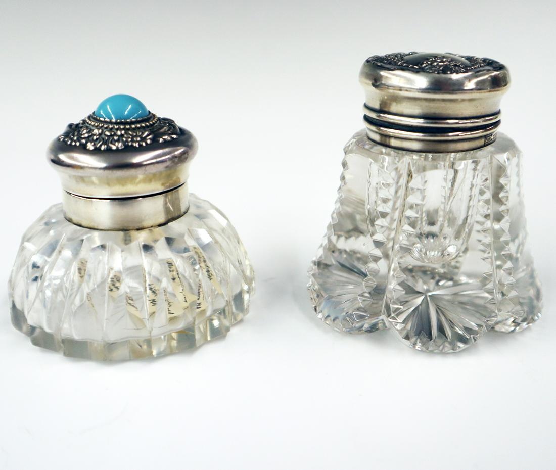 2 Sterling & Cut Glass Inkwells: Two American Late 19th century Sterling & Cut Glass Inkwells. American Brilliant Period cut glass inkwells with Sterling covers and collars, one is decorated with an inset cabochon stone. Minor wear a