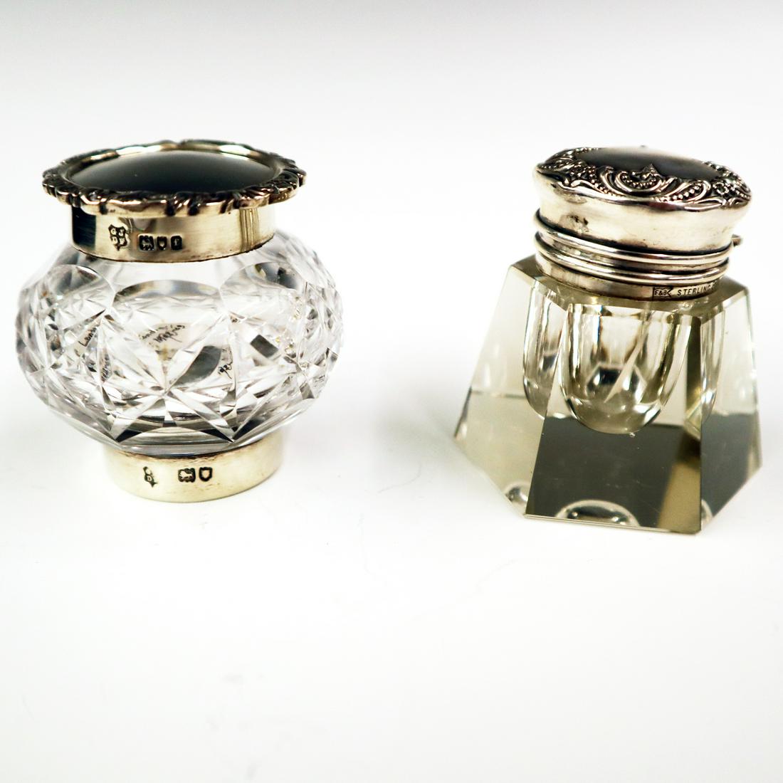 2 Sterling & Cut Glass Inkwells: Two 19th century Sterling & Cut Glass Inkwells. Includes one English inkwell and one American, both with embossed Sterling covers and collars. Minor indentations to covers. Each is 2 1/4" high. ESTIMA