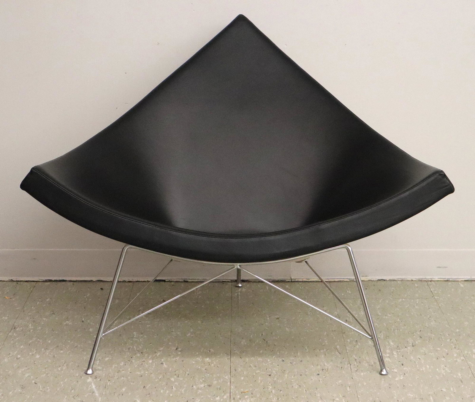 George Nelson Coconut Chair for Vitra: A 2004 George Nelson "Coconut" Chair for Vitra. Having a black leather upholstered seat within a white plastic shell that is supported by stainless steel legs with integrated foot pads. Minor wear to 