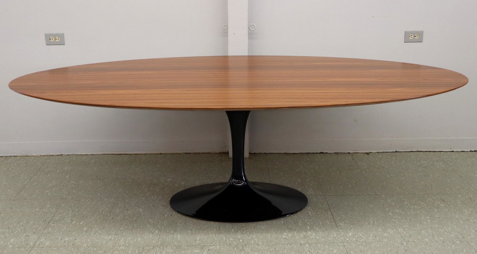 Eero Saarinen/Knoll Dining Table: An Eero Saarinen for Knoll Dining Table, 2016. Oval rosewood top with black enameled oval tulip base, aluminum Knoll label and a paper label with manufacture date of Nov. 01. 2016 affixed to the under