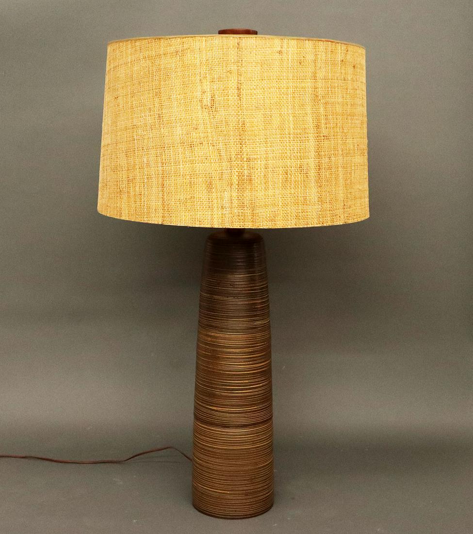 Gordon Martz Tootsie Roll Lamp: A Mid-century Gordon Martz "Tootsie Roll" table lamp. Brown stoneware 3 section lamp with Walnut collar and finial with vintage seagrass covered shade. Original wiring, shade shows wear and minor loss