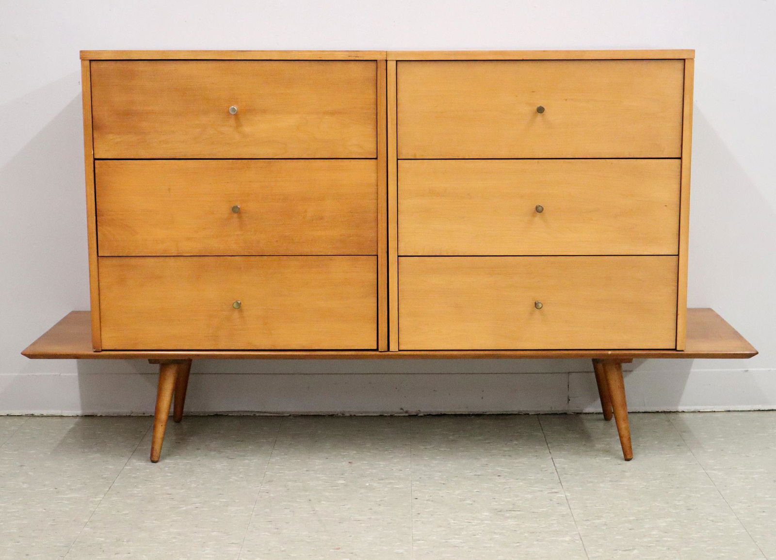 Paul McCobb Dresser: A 1950's Period Paul McCobb "Planner Group" Maple Dresser for Winchendon Furniture. Consisting of two separate chests on a low table with brass knobs and turned tapered legs. Marked with branded label