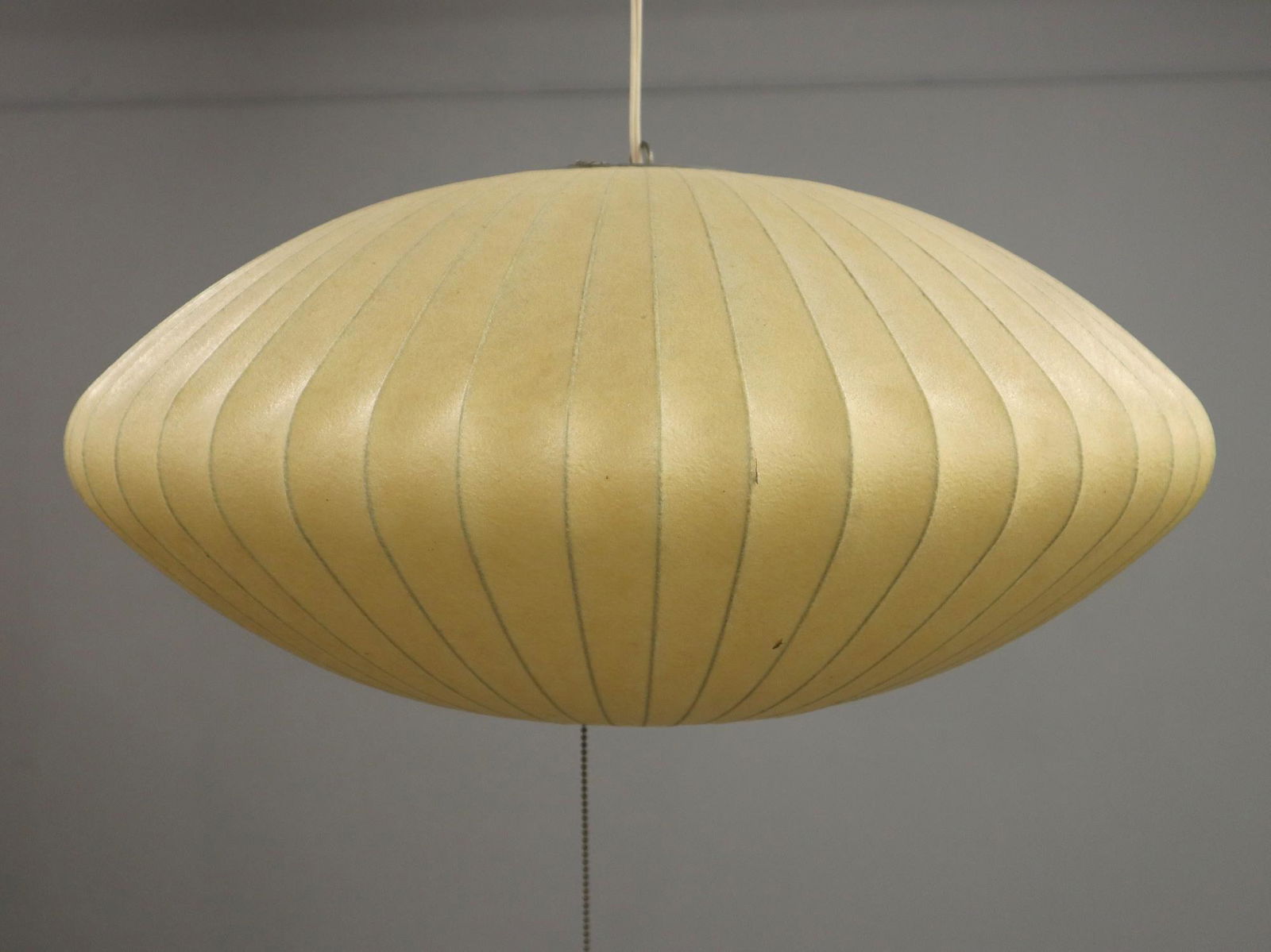 George Nelson Bubble Light: A 1960's George Nelson for Howard Miller "Bubble" pendant light. Stretched parchment shade on a metal frame. Partial label on top ring reads "Bubble lighting Fixtures Howard Miller Clock Co.". Discolo