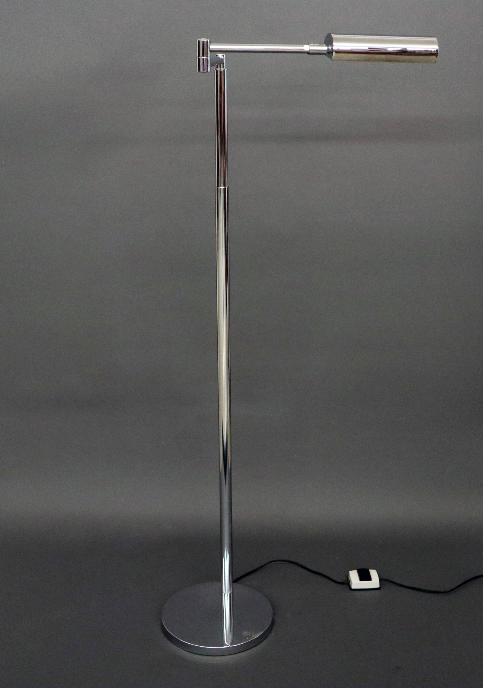 Koch & Lowy Floor Lamp: A 1960's Koch & Lowy Chrome Floor Lamp. Having an articulated arm with adjustable light and height, arm swivel marked "OMI". Small scratch on shade and a small dent at the base. 10 diameter, 42-51" hi