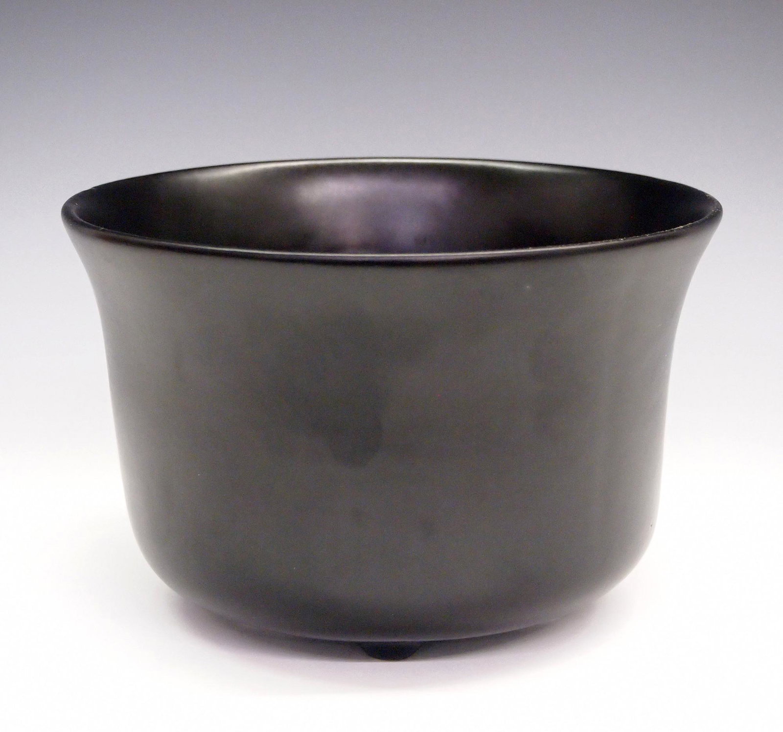 Elsa Peretti for Tiffany Cache Pot: An Elsa Peretti for Tiffany & Co. Black earthenware cache pot. Printed mark. Slight wear, small mark on rim. 5" high. ESTIMATE $50-100