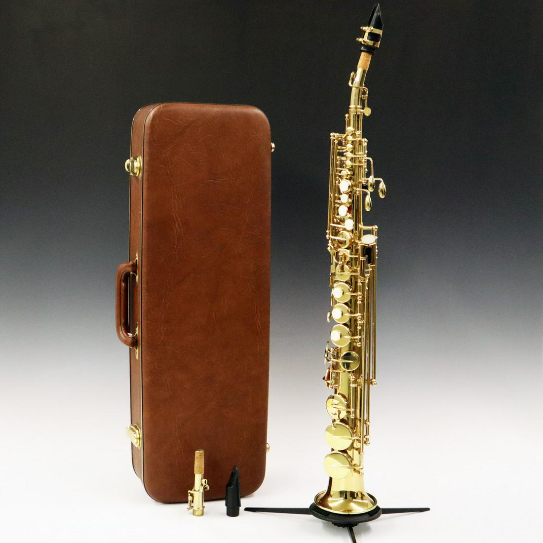 1990's Quest Soprano Saxophone: A 1990's Quest Soprano Saxophone. Includes two necks, one straight and one curved, and two mouth pieces. Includes a brown vinyl hard shell case and original sales invoice. 27 1/2" high. ESTIMATE $400-