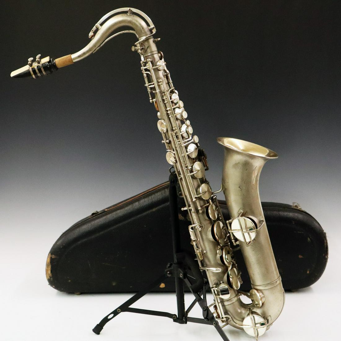 1950's H.N. White "King" Alto Saxophone: A 1950's H.N. White "King" Alto Saxophone. In satin silver plate, having an engraved Bell with company logo, stamped low pitch, serial no. 54378. Includes a hard shell case. Scratches and small losses