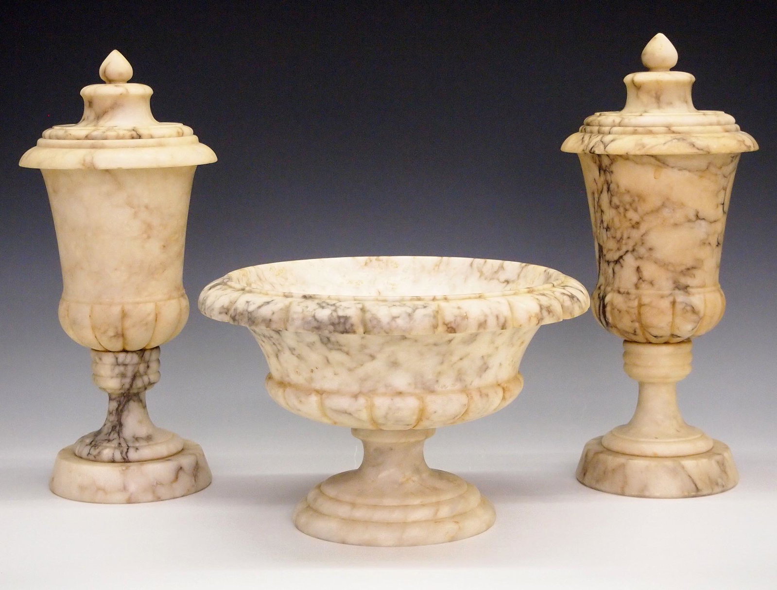 3 pc Italian Alabaster Console set: A 1930's era three piece Italian Alabaster console set with a footed bowl and two covered jars. Wear and minor damage. Up to 12" high. ESTIMATE $100-150