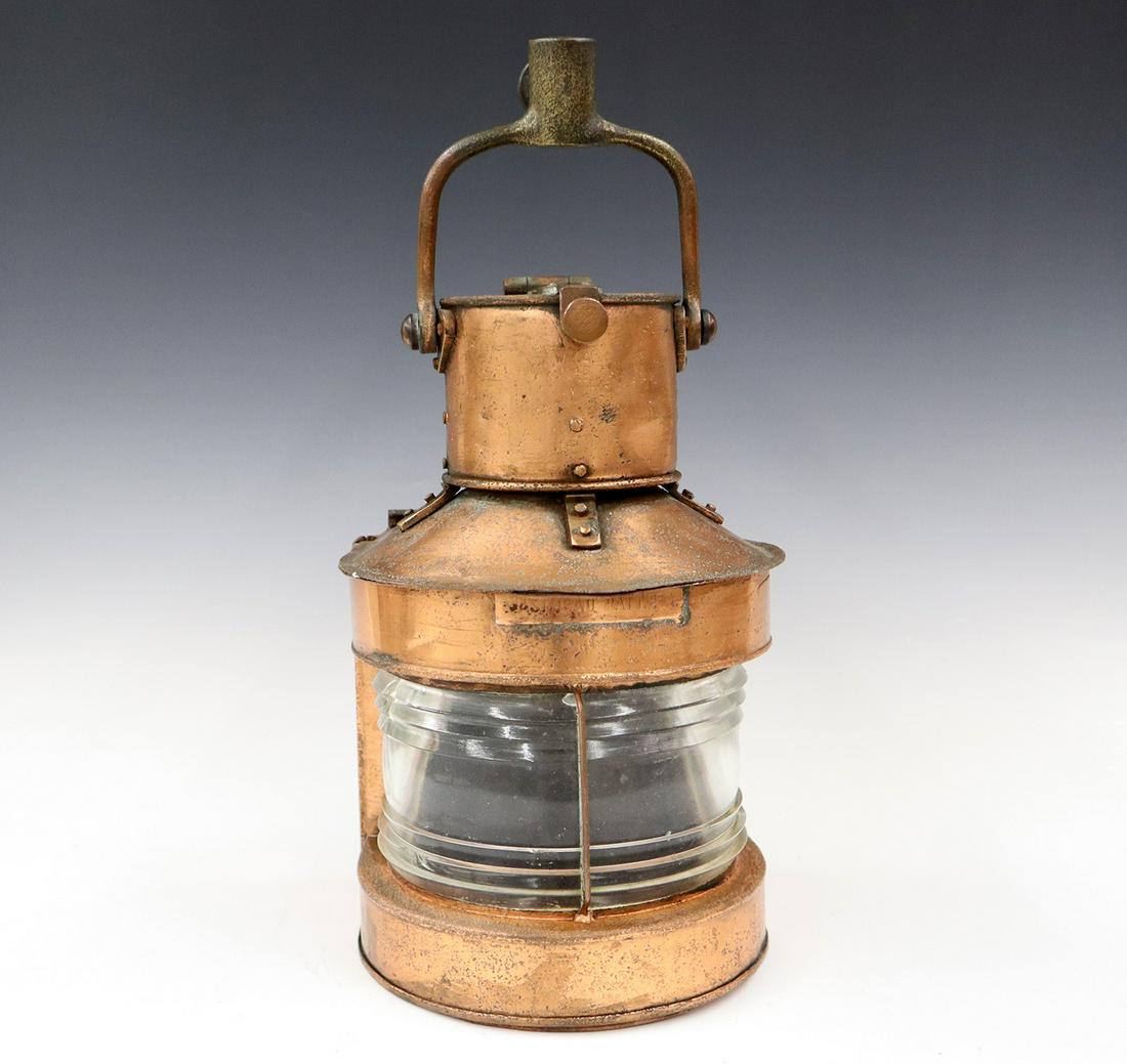 WWII Era Ship's Light: A WWII Era Copper Ship's Light. Having a copper label on the front that reads "Masthead Pat. 25-A", and a clear lens with a socket on the handle, lens is dated "C.B. 1943". Lens is cracked at one side