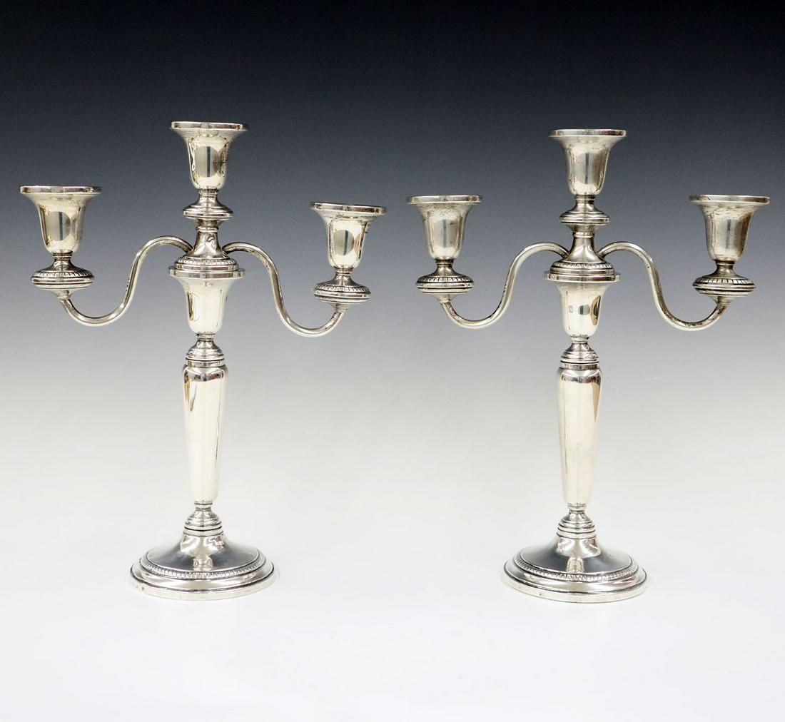 Pr. Revere Co. Sterling Silver Candelabra: A Pair of 1940's Revere Co. Sterling Silver Candelabra. Convertible candelabra with three lights. Minor wear, some indentations to the base. 9 1/2 x 12" high. ESTIMATE $100-200