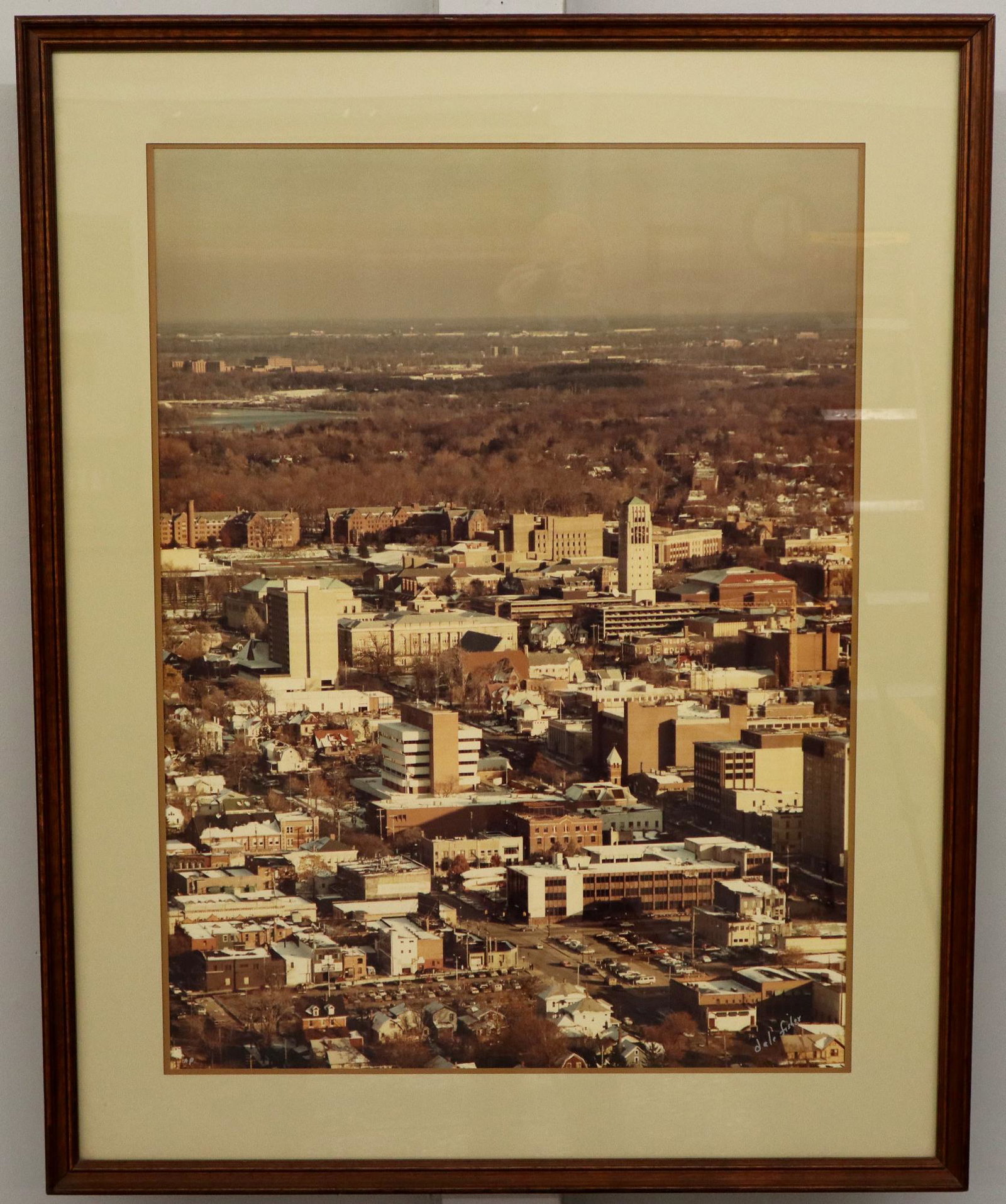 1980's Aerial Photo of Ann Arbor: A 1980's Aerial Photograph of Ann Arbor, Michigan. By Dale Fisher "Heli-Photos", signed lower right, within a Walnut frame. Wear and scratches to the frame, some paint residue. 40 x 50" high overall. 