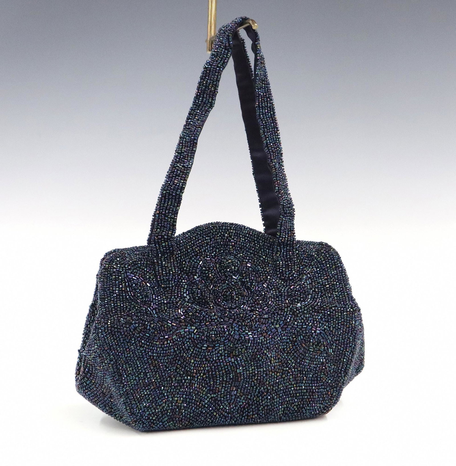 French Beaded Handbag: A 1940's French beaded handbag. Dark irridescent beaded decoration with a subtle raised floral design at the front and "K & G Charlet, Paris and New York" label at the interior. Some replaced and miss