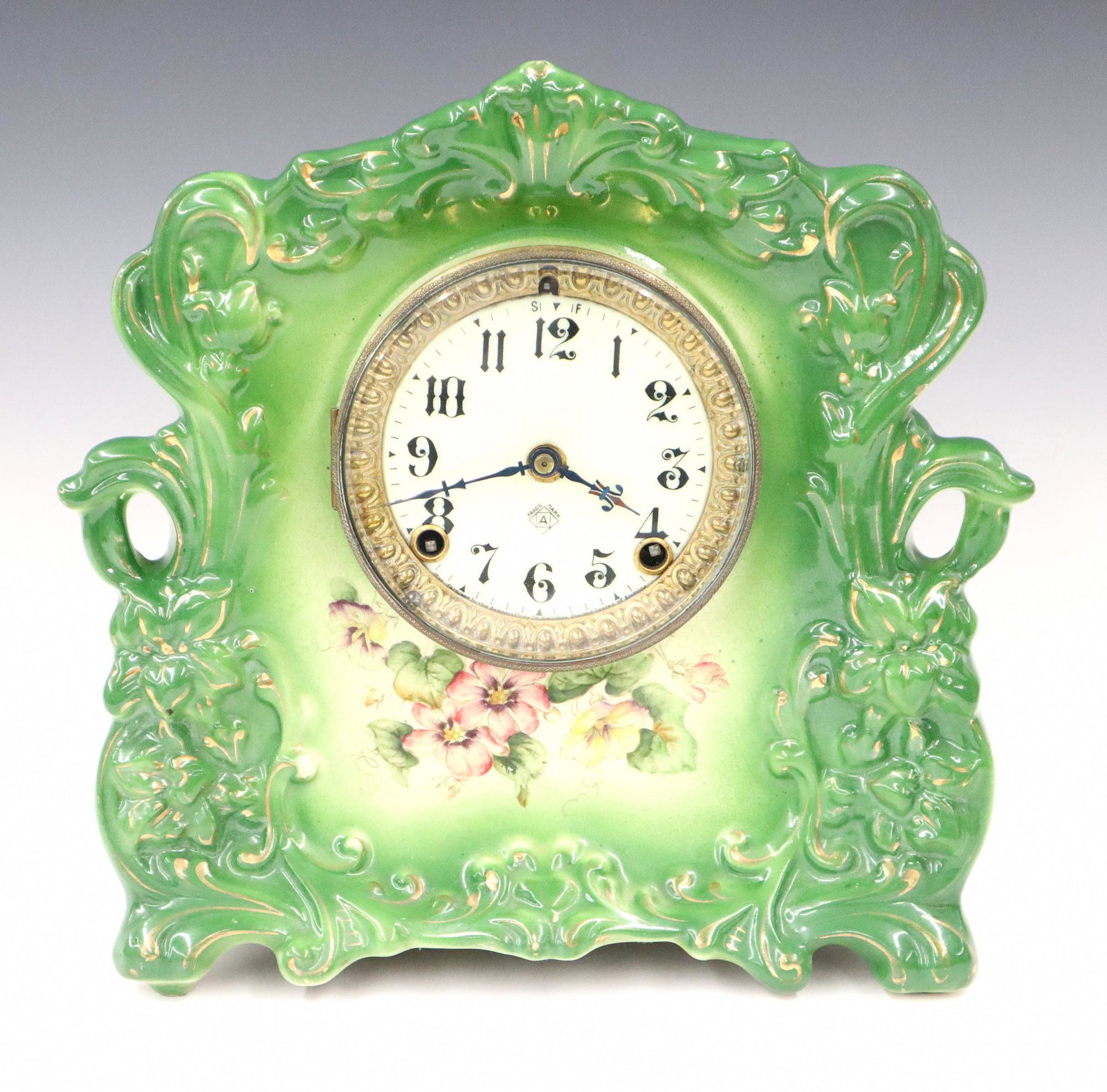 Ansonia Whiz China Shelf Clock: A Turn of the century Ansonia 'Whiz" model China Shelf Clock. Having an 8-day time and strike movement, porcelain dial with Arabic numerals, floral decoration to the case with gilt highlights. Running