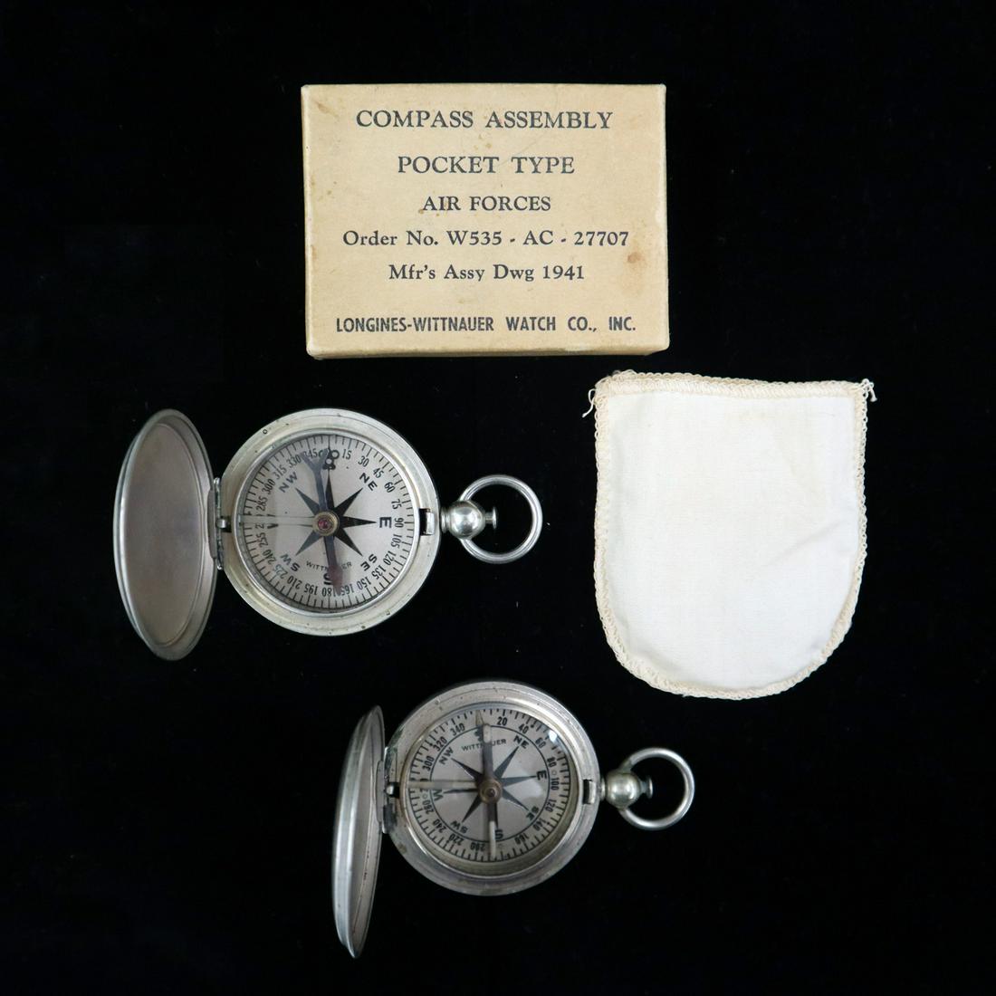 2 Mid 20th Century Pocket Compasses: Two Mid-20th century Pocket Compasses. Each is a WWII era compass by Longines-Wittnauer Watch Co. and is engraved "US" at the front cover, one is in the original box and includes a cotton pouch and ap