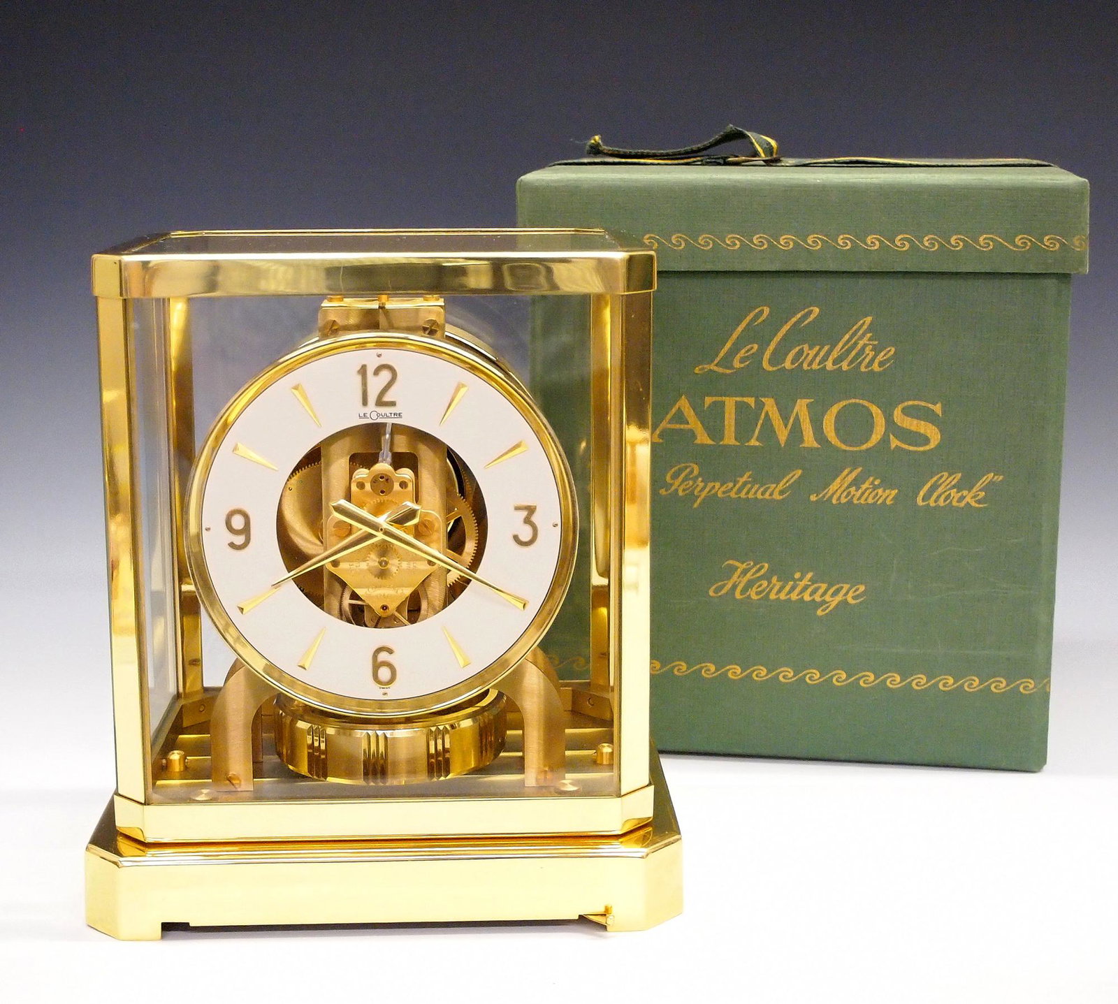 LeCoultre Atmos Clock: A mid 20th century LeCoultre 528-6 Caliber Atmos clock. Perpetual movement runs on atmospheric pressure, with silvered chapter ring and Arabic numerals in a Brass and glass case, with original box and