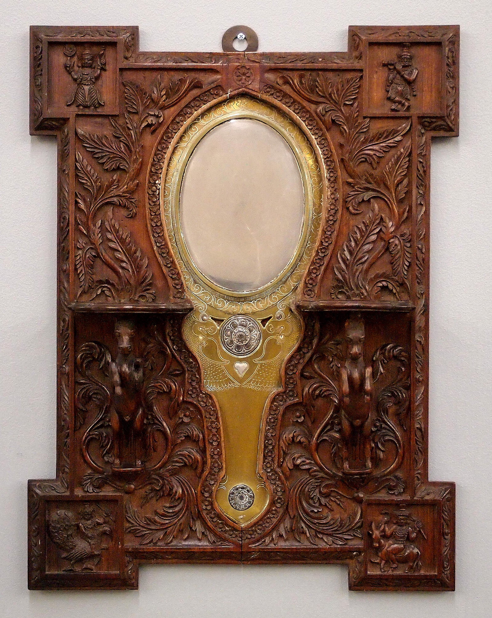 Indian Aranmula Kannadi Wedding Mirror: A late 18th/Early 19th century Indian "Aranmula Kannadi" Brass and Silvered hand mirror. A highly polished metal mirror in an engraved Brass frame with Silver mounts. In a later late 19th century carv