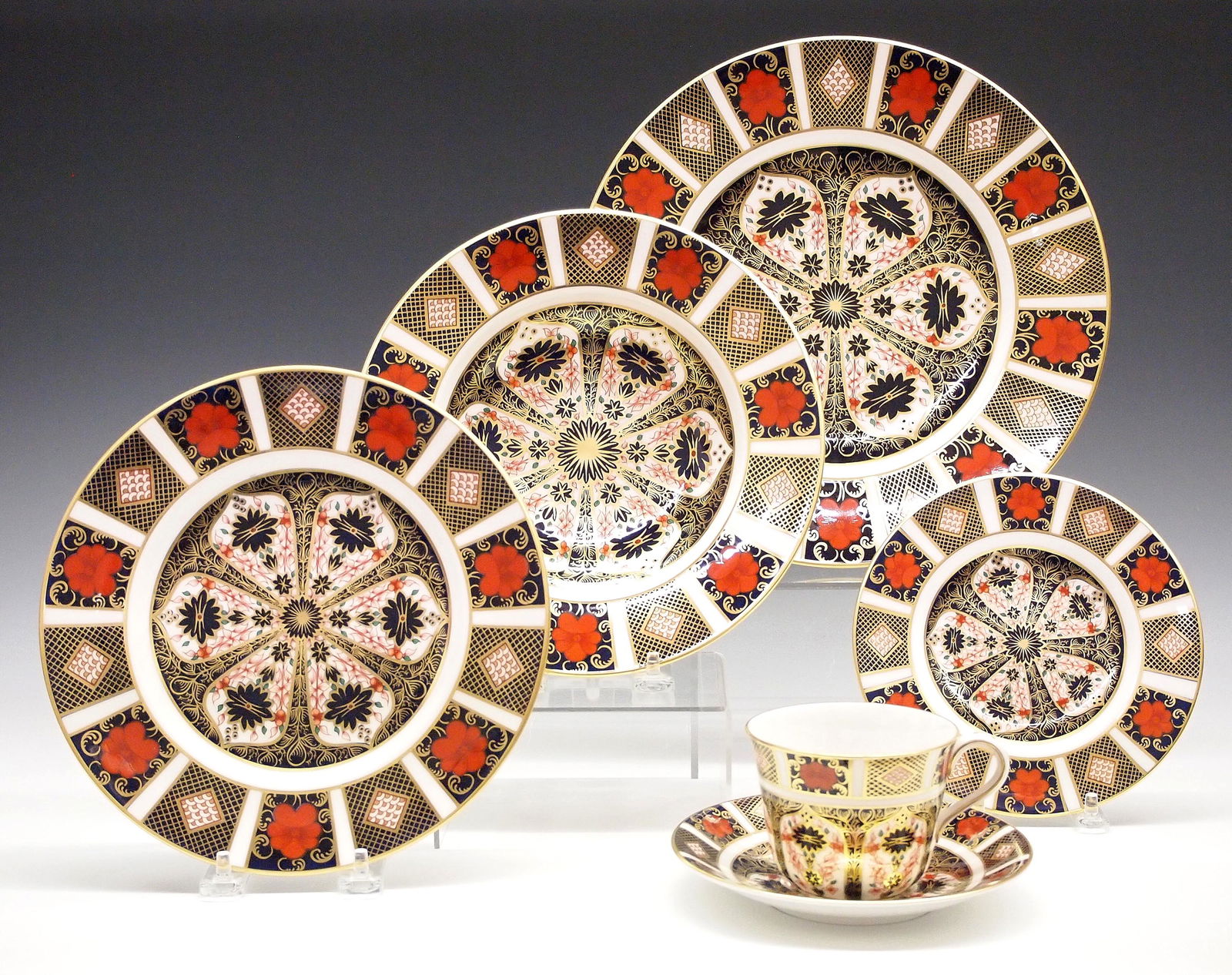 Royal Crown Derby 12 Place Dinner Service: A 20th century Royal Crown Derby "Old Imari" pattern fine bone china dinner service for twelve. Includes twelve 11 1/2" dinner plates, twelve 8 1/2" salad plates, twelve 8 1/2" soups, twelve 6 1/4" br