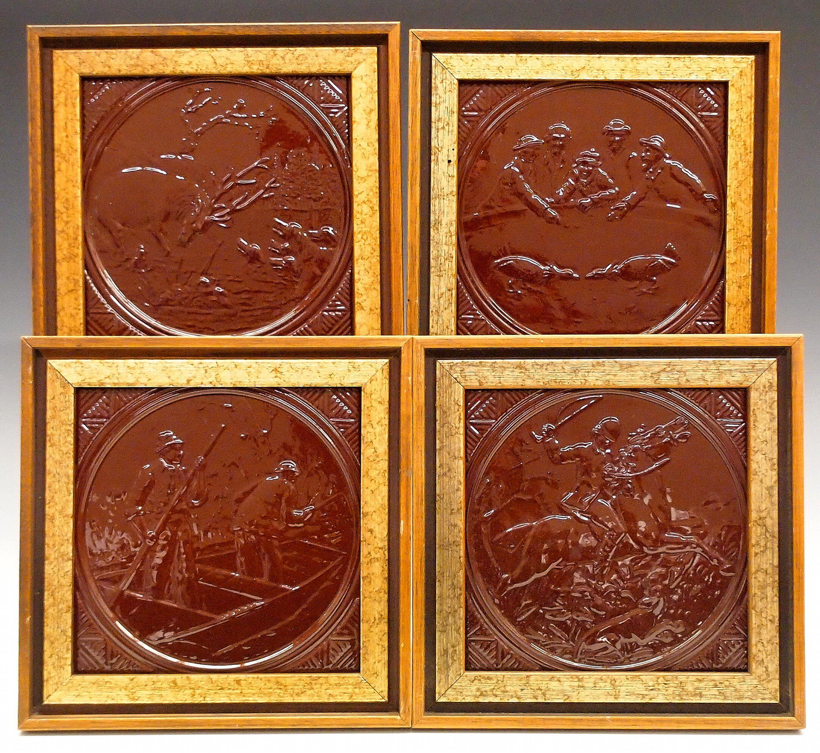 4 Minton Hollins "Blood Sports" Tiles: A set of four 19th century Minton Hollins "Blood Sports" tiles. Each featuring a different scene, including a fox hunt, a cock fight, fishing, and a stag hunt, all covered in an deep Red glaze. Maker'