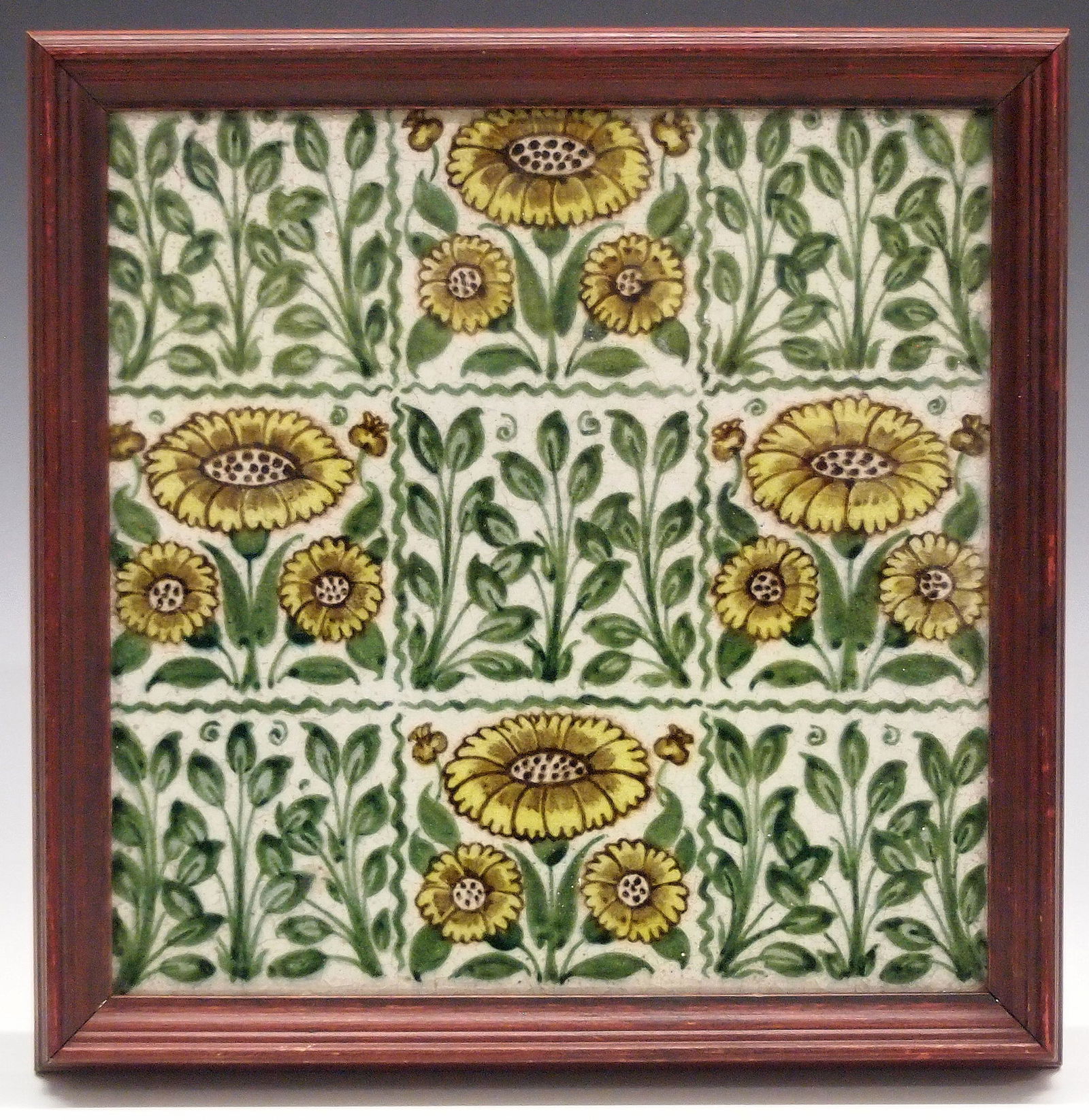 W. De Morgan Tile: A late 19th century William De Morgan Art Pottery tile. Having alternating panels of leaves and "Bedford Park Daisy (in Yellow)" with impressed "Merton Abbey DM" period mark verso. Some crazing and mi
