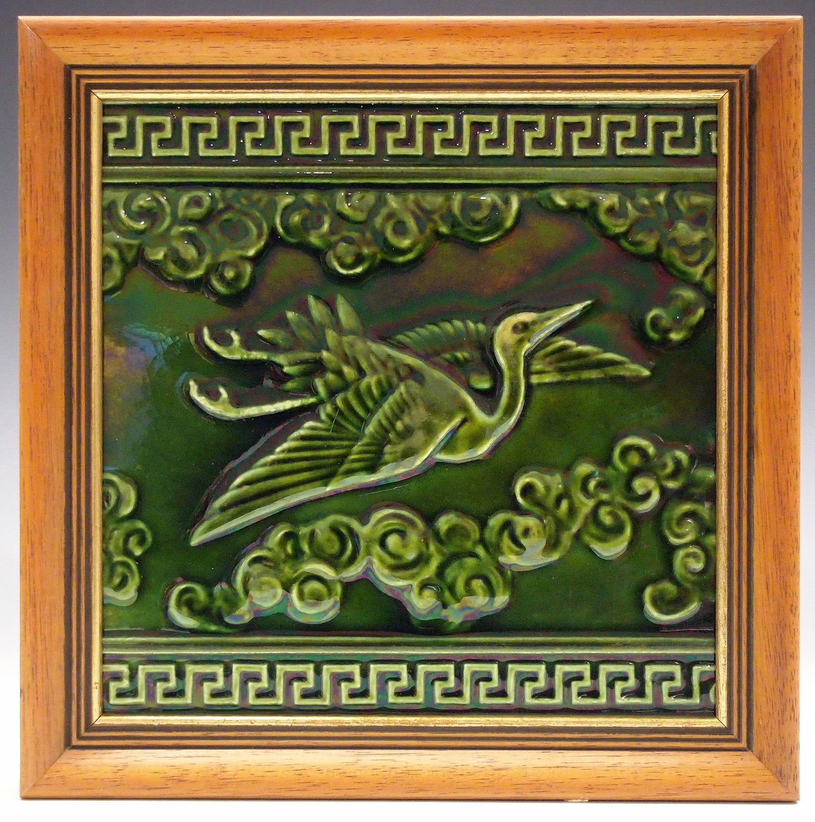 Josiah Wedgwood Tile: A Wedgwood Aesthetic Era ceramic tile, attributed to Christopher Dresser. Having a Japanese inspired motif consisting of Greek key borders that contain a crane flying among the clouds covered by a ric