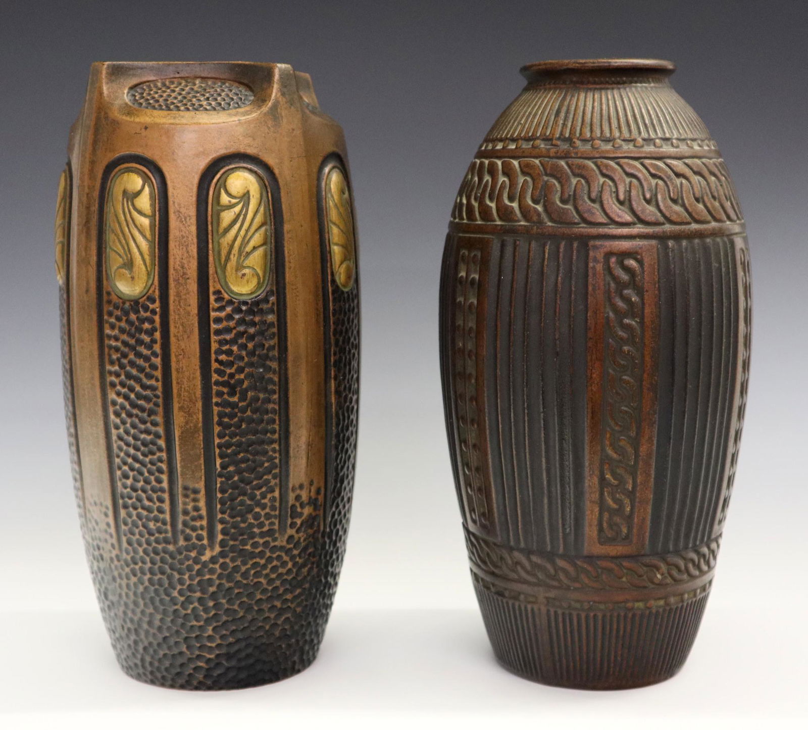 2 Bretby Clanta Ware Vases: Two turn of the century Bretby Clanta Ware Vases. Art pottery vases with metallic brown vases and varying geometric and textured motifs. Both with impressed maker's mark as well as "Clanta Made in Eng