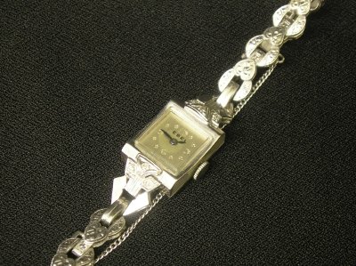 14 k White Gold lady's wristwatch.: A mid 20th century Ebel 14k White Gold Lady's wristwatch. 17 jewel movement marked "Dreffa Watch Co., Swiss". 14k White Gold case and band with 6 small inset Diamonds and engraved detail. Minor wear. 