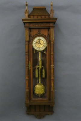German wall clock: A late 19th century German carved Walnut wall clock. 8-day 3-weight movement with quarter hour Grand Sonnerie strike, matching engraved dial, weights and matching compensating pendulum. Architectural
