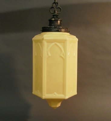 2 Gothic pendant lights: Two 1930's Gothic style pendant lights. Molded glass drop shades with Iron fittings. Includes 1 extra shade. Surface wear and grime. Each fixture 23" high plus chain. ESTIMATE $200-400