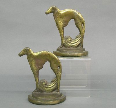 Pr Art Deco bookends: A pair of 1930's Art Deco period cast iron bookends. Greyhound design with Brass patina. Surface wear. Each 5" high. ESTIMATE $50-100