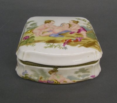 Porcelain box: A mid 20th century porcelain box with hinged cover. Hand painted decoration with Cherubs. Blue painted Sevres type mark. Slight wear. 7 1/4" long. ESTIMATE $50-100