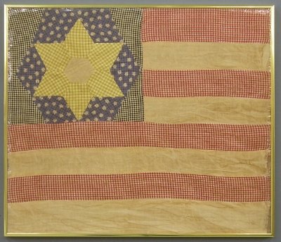 Patchwork flag: An early 20th century patchwork flag with single star and multi color fabric construction. Some discoloration and minor edge damage. In a modern frame, 21 x 18" overall. ESTIMATE $100-200