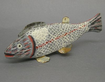 Fish decoy: A 20th century carved wooden fish decoy. Painted finish with applied metal fins. Some paint loss and minor damage. 10 1/2" long. ESTIMATE $50-100